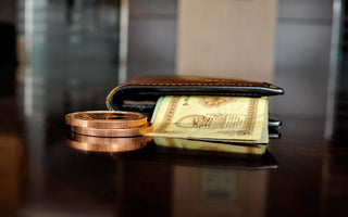 Brown leather bifold wallet with banknotes