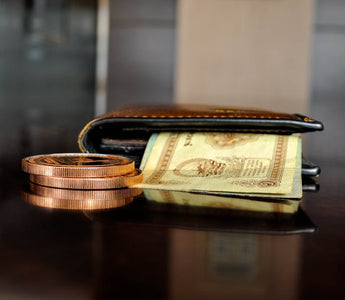 Brown leather bifold wallet with banknotes