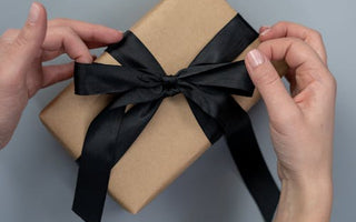 Brown gift box with black ribbon